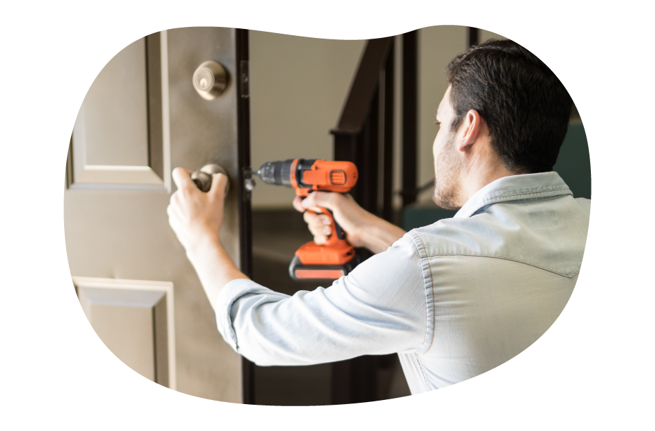 A handyman installing a doorknob at a client's property