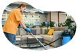 A carpet cleaning company employee vacuuming