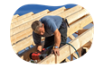 A carpenter building a roof for a client project