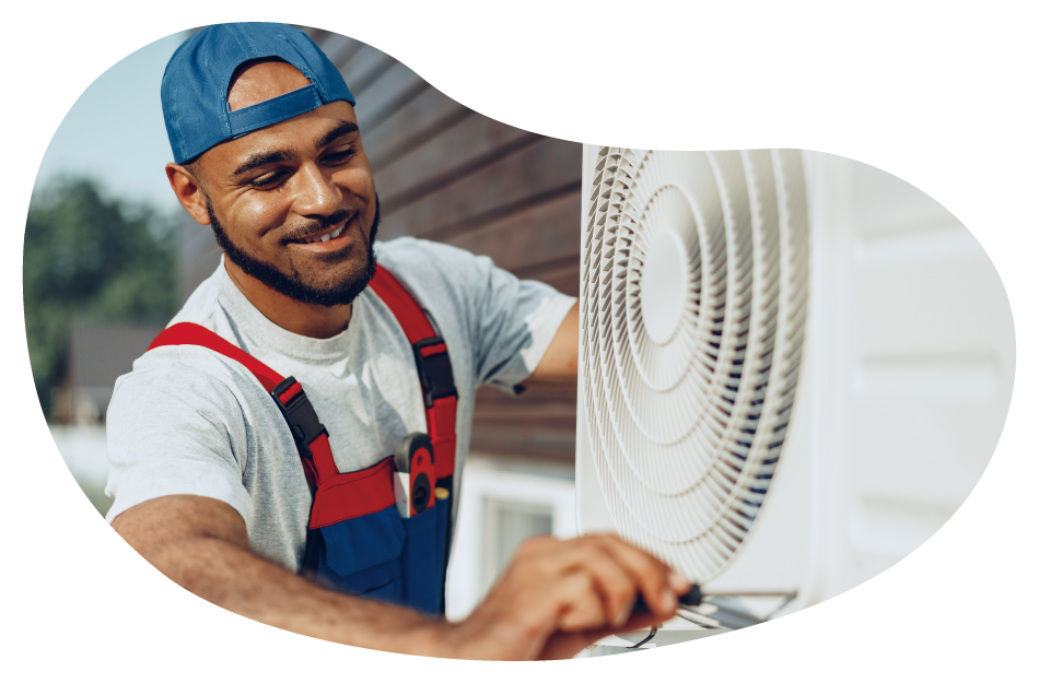 An HVAC contractor working on an AC unit for a customer An HVAC contractor working on an AC unit for a customer