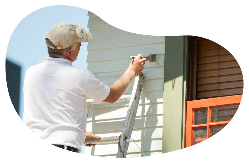 Painter applying a coat of paint onto an exterior wall. Painter applying a coat of paint onto an exterior wall.