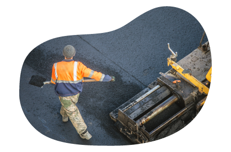 A paving contractor spreading asphalt. A paving contractor spreading asphalt.
