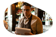 A restaurant owner looks over documents.