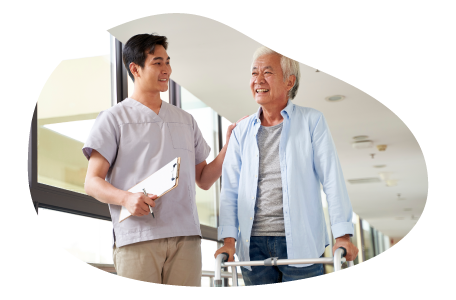 An occupational therapist helps a patient walk during a therapy session An occupational therapist helps a patient walk during a therapy session