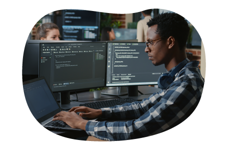 Software developer looking at code on a monitor. Software developer looking at code on a monitor.