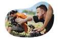 A photographer taking a close up shot during an outdoor shoot