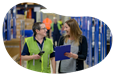 A warehouse worker chats with the owner of an Amazon storefront.